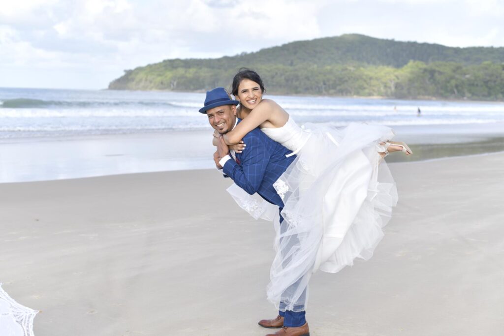 photoshoot with a newly wed couple on the sand at Noosa beach and Casuarina gardens